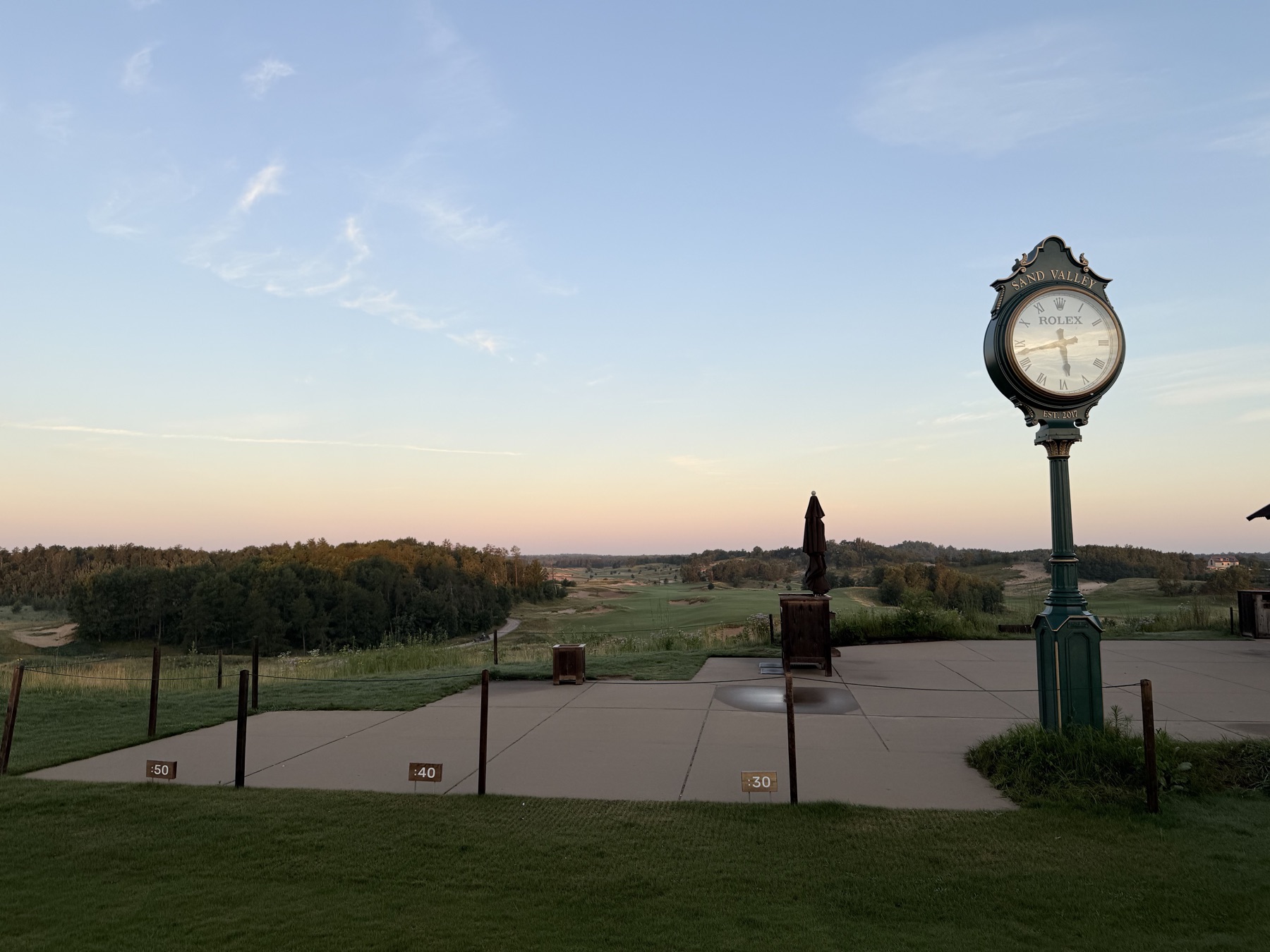 Close view of the course clock, with Sand Valley written above its face.